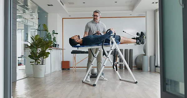 Chiropractor using traction on patient as a form of stretching