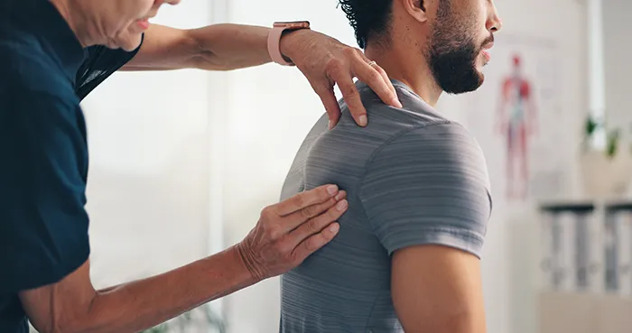 man receiving chiropractic care on his shoulder